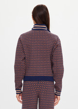 THE UPSIDE women's brown organic cotton Lumiere Margot Knit Jacket is a knitted long sleeve with a geometric star pattern, front pockets and contrast stripes around the sleeves. Made for lifestyle.