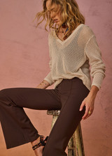 THE UPSIDE women's creme organic cotton Josephine V Neck Knit features a lightweight relaxed shape with a deep V neckline and mini ribbed hem, neckline and cuffs. Made for lifestyle.