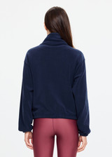 THE UPSIDE women’s navy recyled Sol Fleece Jacket offers a relaxed fit and features a zip through front, front zip pockets, elasticated waist and cuffs and contrast paracord zip pullers. Made for lifestyle.