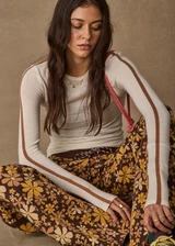 THE UPSIDE women's floral organic cotton Copacabana Juniper Knit Pant offers a soft and supportive fit with a straight leg silhouette, side stripes and drawcord waistband. Made for lifestyle.