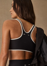 THE UPSIDE women's black Sol Jade Racerback Sports Bra is designed for a soft and supportive fit and features a scooped racerback, contrast binding and removable cups. Made for yoga and pilates.