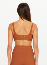 THE UPSIDE women’s brown recycled jacquard Mariana Bridie Sports Bra is designed for a soft, supportive fit and features removable cups and textured fabrication. Made for yoga and pilates.