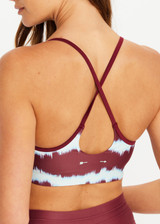 THE UPSIDE women’s tie dye recycled Rio Badu Crossback Sports Bra is a soft and supportive and features a scooped neckline, crossback straps and removable cups. Made for yoga and pilates.