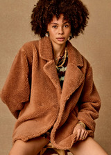 THE UPSIDE women’s brown recycled polyester Gracie Teddy Coat is a relaxed fit mid length coat and features a double breasted closure, welt pockets and faux shearling fabrication. Made for lifestyle.