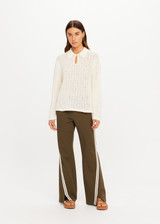 THE UPSIDE women's cream organic cotton Frederica Knit Top is designed for a relaxed fit with an open geometric knit construction, collared neckline and abalone shell button detailing. Made for lifestyle.
