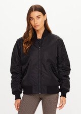 THE UPSIDE women's black Tribute Bomber Jacket is a true to size fit and features a classic bomber silhouette, ribbed trims, ruched sleeves and multiple functional pockets. Made for lifestyle.