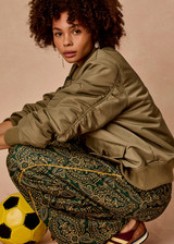 THE UPSIDE women's olive Tribute Bomber Jacket is a true to size style featuring a water resistant finish, paisley lining, ruched sleeve detailing and multiple utility pockets. Made for lifestyle.