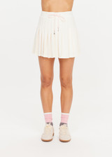 THE UPSIDE women’s cream recycled Cadiz Pleated Skirt is designed for a true to size fit and features a pleated design, built in inner short with pockets and drawcord detail. Made for tennis.