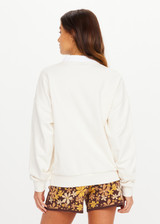 THE UPSIDE women's natural organic cotton Pascal Collared Crew offers a relaxed fit and features a collared neckline, scalloped edge detailing and ribbed trims. Made for lifestyle.