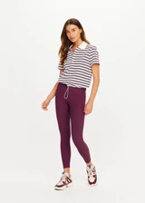 THE UPSIDE women's stripe organic cotton Sophie Cropped Polo Shirt is designed for a cropped fit and features a collared neckline, button front closure and adjustable drawcord hem detailing. Made for lifestyle.