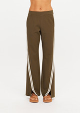 THE UPSIDE women's green Petra Flare Pant combines a true-to-size mid rise fit with side seam pockets, striped side tape and hem splits. Made for lifestyle.