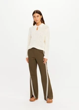 THE UPSIDE women's green Petra Flare Pant combines a true-to-size mid rise fit with side seam pockets, striped side tape and hem splits. Made for lifestyle.