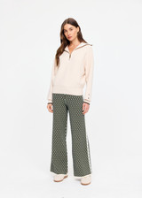 THE UPSIDE women's cream organic cotton Kairo Half Zip Knit is designed for a relaxed fit with a jacquard knit construction, oversized collar and contrast stripe detailing. Made for lifestyle.