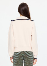 THE UPSIDE women's cream organic cotton Kairo Half Zip Knit is designed for a relaxed fit with a jacquard knit construction, oversized collar and contrast stripe detailing. Made for lifestyle.
