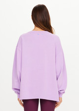 THE UPSIDE women's purple organic cotton Soul Lou V Neck Sweater offers an oversized fit with drop shoulders, ribbed trims and an embroidered logo detail. Made for lifestyle.