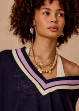 THE UPSIDE women's navy linen cotton blend Bonita V Neck Knit features a regular fit and dropped shoulders, striped neckline detailing and ribbed trims. Made for lifestyle.