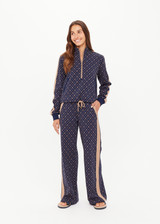 THE UPSIDE women's monogram jacquard Ezra Morgan Quarter Zip features elasticated cuffs, drawcord hem, and front pockets. Made for lifestyle.