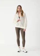 THE UPSIDE women's cream Hunter Knitted Jacket is designed for a relaxed fit and features an open knit construction and zipper opening. Made for lifestyle.
