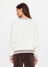THE UPSIDE women's cream Millie V Neck Knit Sweater is designed for a relaxed fit and features a high v neckline and chocolate metallic stripes along cuffs, neckline and hem. Made for lifestyle.