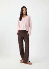 THE UPSIDE women's brown Petra Flare Pant is true to size with pink striped side tape and tonal drawcord with dipped ends. Made for lifestyle.