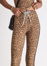 THE UPSIDE women's animal Panthera 25 Inch Midi Pant is designed for a mid-rise fit and features navy contrast binds down the side seams and a blue elastic drawcord. Made for yoga and pilates.