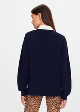 THE UPSIDE women's navy organic cotton Wonder Knit Polo is designed for a relaxed fit and features long sleeves with a contrast cream collar and placket. Made for lifestyle.