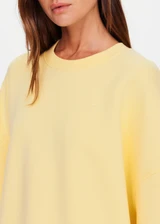 THE UPSIDE women's yellow organic cotton Paloma Crew is designed for a boxy fit and features a drop shoulder and ribbed neckline, hem and cuffs. Made for lifestyle.