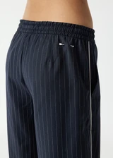 THE UPSIDE women's stripe Wool Elita Pant is a mid-rise, wide leg pant and features cream piping along side seams and maroon paracord drawcord. Made for lifestyle.