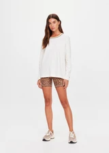 THE UPSIDE women's natural organic cotton Mali Long Sleeve Top is a relaxed fit and features a ribbed neckline in butter with navy piping. Made for lifestyle.