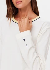 THE UPSIDE women's natural organic cotton Mali Long Sleeve Top is a relaxed fit and features a ribbed neckline in butter with navy piping. Made for lifestyle.