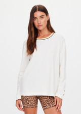 THE UPSIDE women's natural organic cotton Mali Long Sleeve Top is a relaxed fit and features a ribbed neckline in butter with navy piping. Made for lifestyle.
