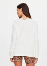 THE UPSIDE women's natural organic cotton Mali Long Sleeve Top is a relaxed fit and features a ribbed neckline in butter with navy piping. Made for lifestyle.