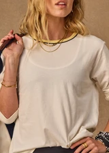 THE UPSIDE women's natural organic cotton Mali Long Sleeve Top is a relaxed fit and features a ribbed neckline in butter with navy piping. Made for lifestyle.