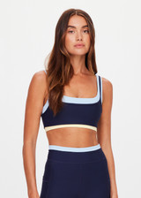 THE UPSIDE women's navy recycled nylon Hermosa Ava Double Layer Bra is mid coverage and features a scooped neckline and contrast elasticated underbust  in butter. Made for yoga and pilates.