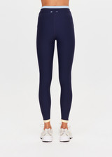 THE UPSIDE women's navy recycled nylon Hermosa 25 Inch Pocket Legging is mid rise and features a contrast hem cuff in butter and pockets at the side. Made for yoga and pilates.