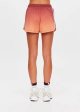 THE UPSIDE women's red recycled polyester Maya Billie Run Short is mid rise and features light blue mesh tape down side seams and side pockets. Made for running.