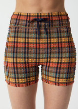 THE UPSIDE women's check Del Sol 4 Inch Spin Short is mid rise and features a navy elastic drawcord with aglets and is fully lined. Made for yoga and pilates.