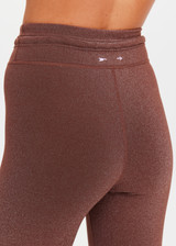THE UPSIDE women's espresso metallic Galaxia 25inch Legging is mid-rise and features a purple drawcord with aglets and embroidered purple arrow logo. Made for yoga and pilates.