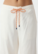 THE UPSIDE women's cream La Paz Malika Wide Leg Pant is a mid-rise straight leg fit and features an elasticated back waistband, an orange drawcord, an embroidered palm tree motif and side seam pockets. Made for lifestyle.