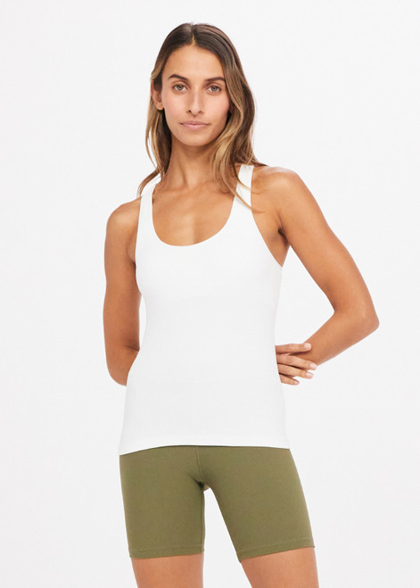 THE UPSIDE Balance Seamless Lenny Tank in White is a mid-coverage scoop neck seamless rib tank with cross back straps and shelf bra with removable cups.