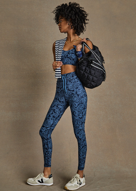 THE UPSIDE women's indigo paisley Nouveaux 25 Inch Midi Pant made in Recycled Soft Peached features a 25 inch leg length, an elasticated drawcord through waistband, arrow logo at centre back, and moisture wicking properties.