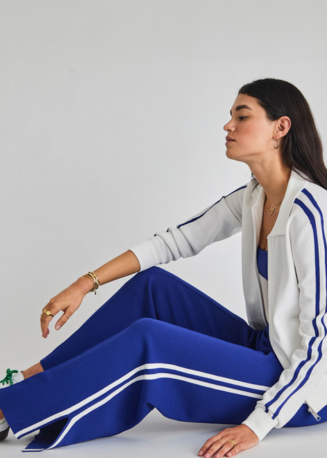 THE UPSIDE women's blue Carnaby Freya Knit Pant is a knitted straight leg pant, featuring a white side stripe and elasticated waistband for comfort. Designed for walking and light movement.