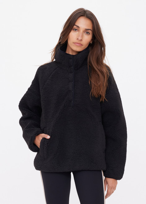 THE UPSIDE women's black Harlow Fleece Pullover offers a relaxed fit made from recycled warm fleece fabric and features zip pockets and an elastic at waist and cuffs to keep warmth in. Made for lifestyle.