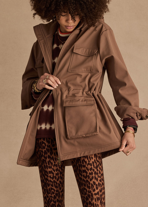 THE UPSIDE women's brown Freddie Fleece Lined Anorak is made from bonded water resistant fabric with internal warm polar fleece and features external pockets with flap closure and drawcord with toggles to cinch in waist.