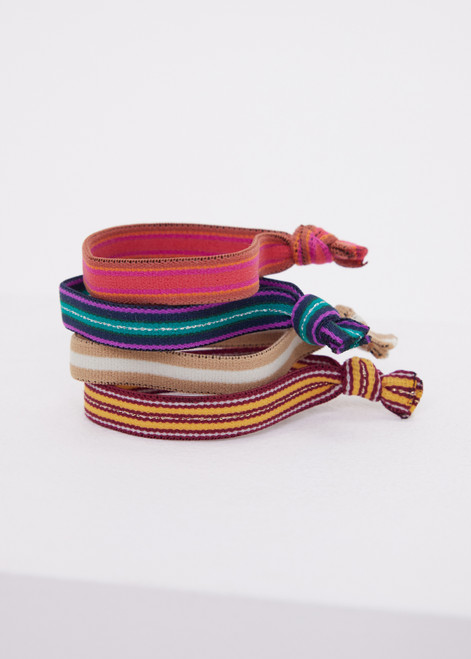 THE UPSIDE 4-Pack Hair Ties features soft elastics in tones of green, purple, silver, sand, burgundy, yellow, pink, and orange. Perfect for daily wear.