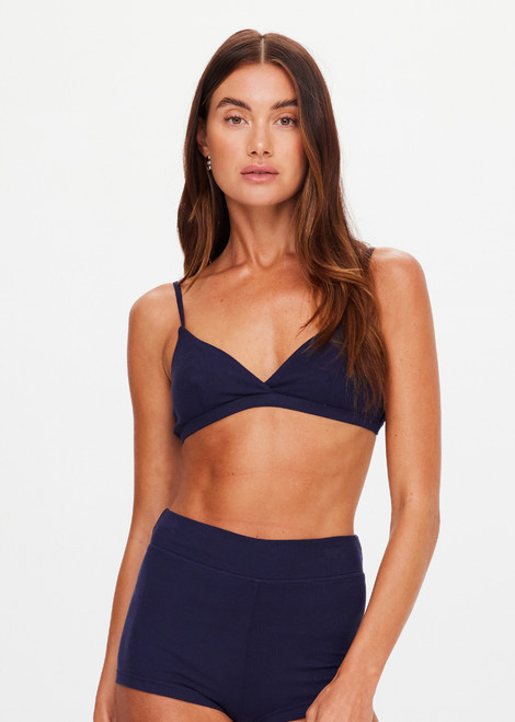 THE UPSIDE women's navy Palais Rib Capri Bra is designed to be worn under sheer garments and features a v neckline with adjustable straps in a soft ribbed fabrication. Made for lifestyle.