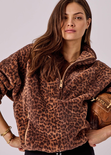 THE UPSIDE women's leopard Harlow Fleece Pullover is designed for a relaxed fit with raglan sleeves crafted from recycled sherpa fabrication and features zip pockets and an elasticated waistband and cuffs for warmth.