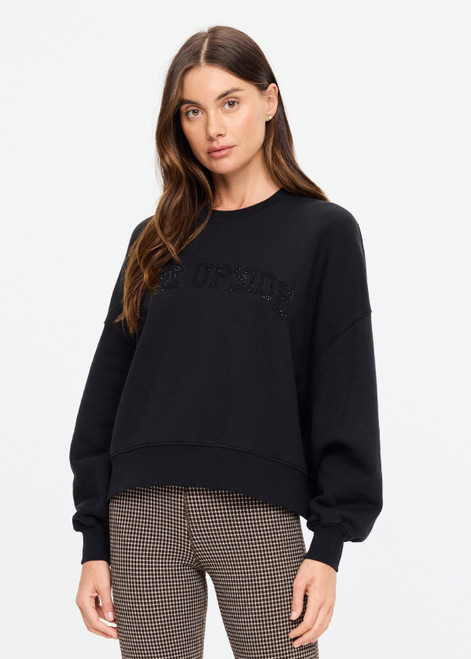THE UPSIDE women's black organic cotton Paloma Crew is designed for an oversized fit and features dropped shoulders, ribbed trims and rhinestone logo detailing. Made for lifestyle.
