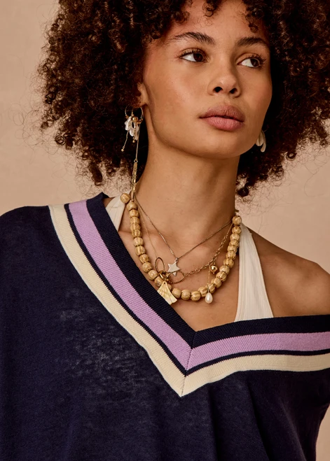 THE UPSIDE women's navy linen cotton blend Bonita V Neck Knit features a regular fit and dropped shoulders, striped neckline detailing and ribbed trims. Made for lifestyle.