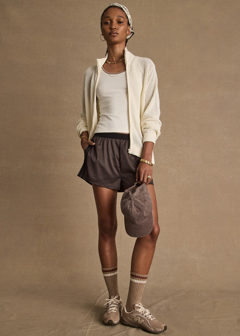 THE UPSIDE women’s brown Levi Run Short is a mid-rise style with a curved hem, ribbed elastic waistband and black mesh tape. Made for running.